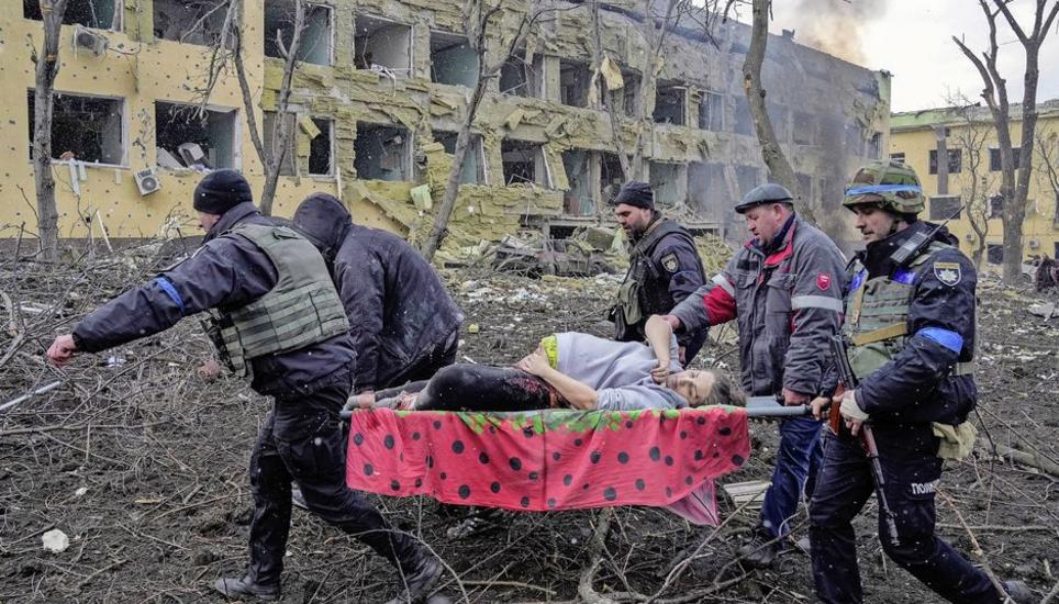 FILE- Iryna Kalinina, 32, an injured pregnant woman, is carried from a maternity hospital that was damaged during a Russian airstrike in Mariupol, Ukraine, on 9 March 2022. Associated Press photographer Evgeniy Maloletka won the World Press Photo of the Y