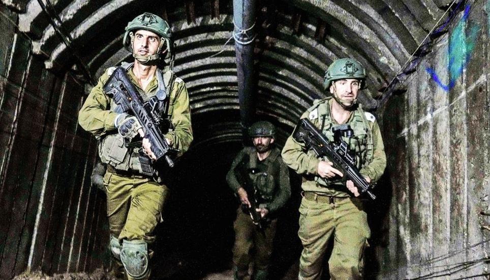 Israeli soldiers are seen in a tunnel that the military says Hamas militants used to attack the Erez crossing in the northern Gaza Strip, Friday, Dec. 15, 2023. The army is battling Palestinian militants across Gaza to retaliate for Hamas' Oct. 7 attack o