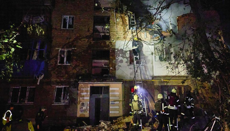 epa11381050 Ukrainian rescuers working at the site of the shelling of a residential building in Kharkiv, Ukraine, 31 May 2024 amid the Russian invasion. At least 5 people died and 25 were wounded in the overnight rocket attack on the residential area acco