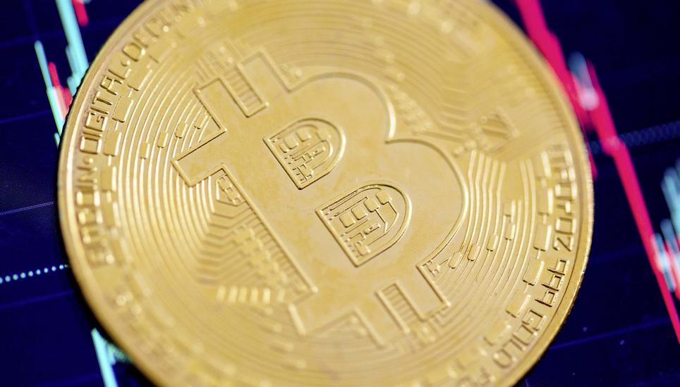 ARCHIV - 22.05.2023, Berlin: Eine Bitcoin-MÃ¼nze liegt auf einem Bildschirm, der den Bitcoin - US-Dollar Kurs zeigt. Als die Welt im Herbst 2008 am Rand einer globalen Finanzkatastrophe stand, tauchte der Bitcoin als Gegenentwurf zum traditionellen Fina