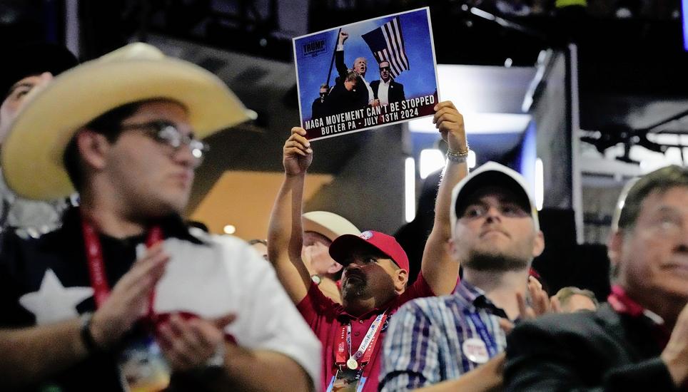 A delegate holds up a photo during the Republican National Convention Tuesday, July 16, 2024, in Milwaukee. (AP Photo/Nam Y. Huh)