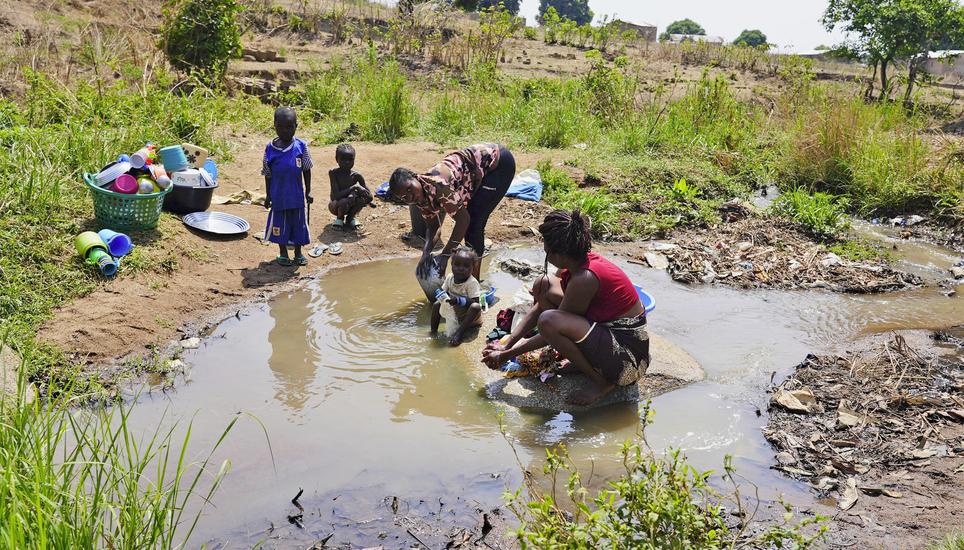 Women wash clothes and dishes in a stream in Bouar, Central African Republic, Thursday, March 7, 2024. Nearly 5,000 fighters have put down their arms in Central African Republic since a disarmament program launched nearly a decade ago. Yet former rebels, 